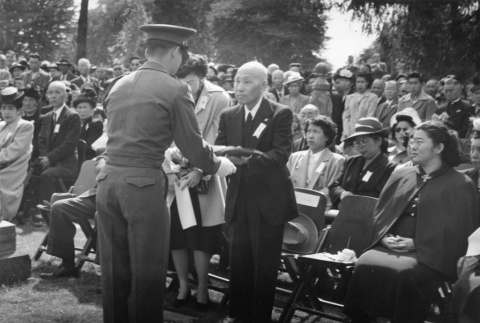 Man receiving flag (ddr-densho-1007-459)