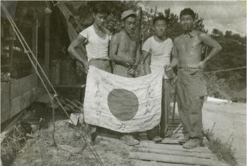 Nisei soldiers with captured Japanese flag (ddr-densho-179-93)