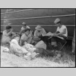 Japanese Americans sitting outside barracks (ddr-densho-151-278)