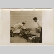 Man and woman grilling (ddr-densho-433-1106)