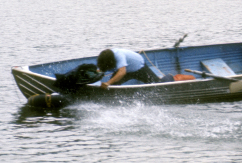 Stuart Wong trying to retrieve a bag in the water (ddr-densho-336-884)