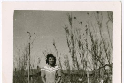 Women Standing by bare trees outside barracks (ddr-densho-329-1363)