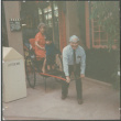 Chester Sakura pulling Agnes and grandson on rickshaw (ddr-densho-523-465)