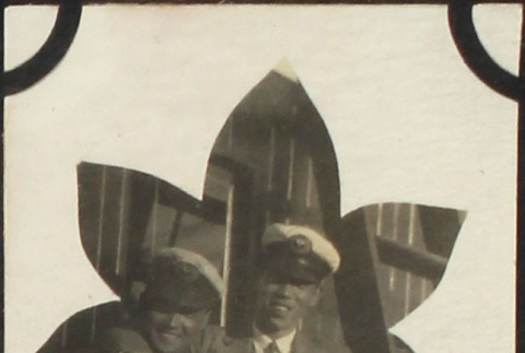 Two men in caps standing by ladder (ddr-densho-423-506)