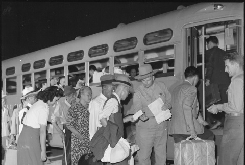Japanese Americans boarding buses (ddr-densho-37-784)