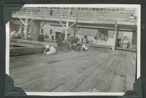 Men relaxing around pier (ddr-densho-540-95)