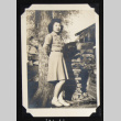 Nori by a wood stack (ddr-densho-542-606)