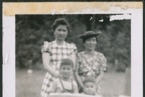Mary, Paul, and Kenji Ima with unidentified woman behind the Fukuyama family gravestone (ddr-densho-483-1056)