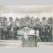 Group of people standing and seated around coffin (ddr-densho-332-47)