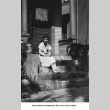 Mary Kondo sitting on steps of house (ddr-ajah-6-115)