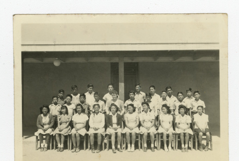Group of Nisei 8th graders with a teacher outside a barrack (ddr-csujad-44-28)