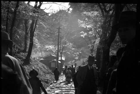 People walking on stone path (ddr-densho-426-289)