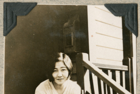 Hatsue Aoki sitting on porch (ddr-densho-383-50)