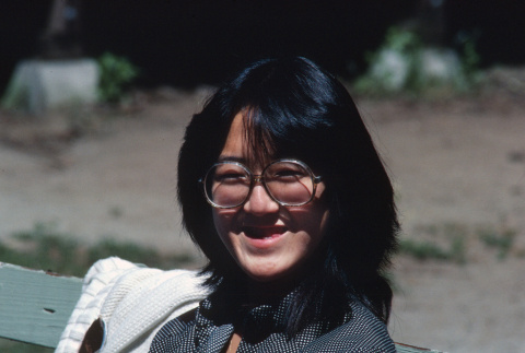 Ann Shimakawa sitting on a bench (ddr-densho-336-1345)