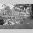 Visitors in the Garden in front of a pond along Mapes Creek, Fujitaro Kubota near tree (ddr-densho-354-45)
