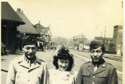 Two soldiers and a woman at the train station (ddr-densho-22-378)