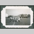 Men playing football on field (ddr-densho-475-707)