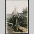 Photo of a man with a bicycle (ddr-densho-483-725)