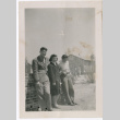 Woman and two men leaning on wall (ddr-densho-329-1325)