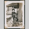 Girl poses next to a tree (ddr-densho-463-177)