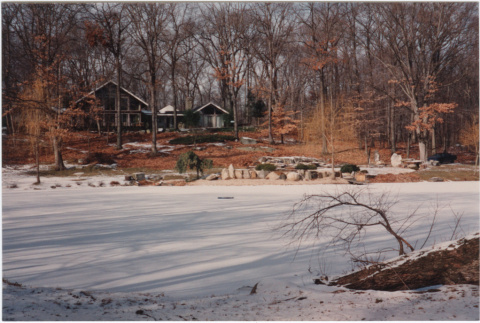 Garden in snow with house in the distance at the Kaye Project (ddr-densho-377-78)