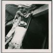 Two men working on support post, one hammering (ddr-densho-426-2261)