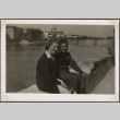 Man and woman sitting on wall by river (ddr-densho-466-64)
