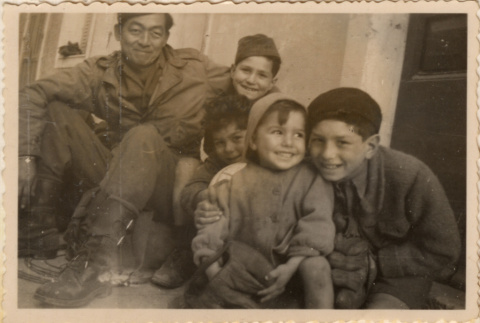 Soldier posing with four children (ddr-densho-466-291)