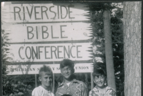 Four boys standing by Riverside Bible Conference sign (ddr-densho-523-241)