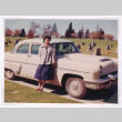 Mitzi (Nakahara) Isoshima standing in front of a car in a cemetery (ddr-densho-477-316)