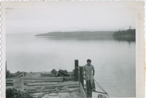 A man sitting on a dock (ddr-densho-296-241)