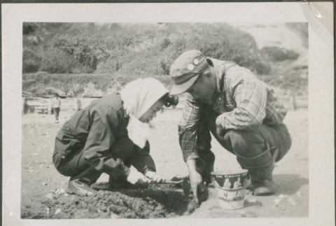 A woman and man digging clams (ddr-densho-201-916)