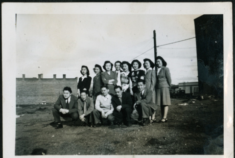Group of men and women in an empty lot (ddr-densho-395-90)