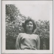 A woman in front of flowering trees (ddr-densho-298-201)