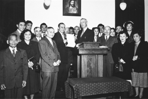 Group standing at podium for transfer of deed for church property (ddr-ajah-4-12)