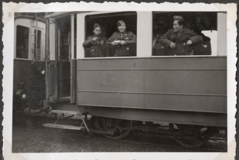 Three men looking out train window (ddr-densho-466-75)