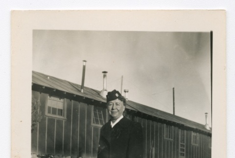Henrietta Schoen posing in front of barracks (ddr-densho-223-10)