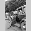 Man and woman inside car, man sitting on running board (ddr-densho-426-2018)