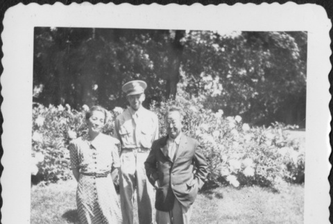 Man in uniform standing with man and woman (ddr-densho-434-407)