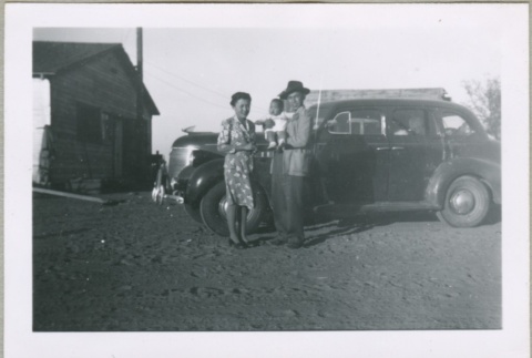 A family standing in front of a car (ddr-densho-300-36)