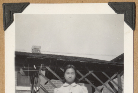 Girl outside a house (ddr-densho-542-182)