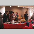 Group standing by display of table setting (ddr-densho-426-375)