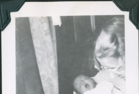 Photo of a woman holding a baby (ddr-densho-483-1287)