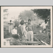 Group standing by outdoor grill (ddr-densho-293-135)
