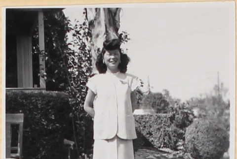 Woman standing by tree outside house (ddr-densho-522-14)