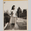 Woman standing on gravel driveway (ddr-densho-522-21)