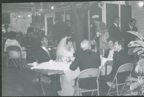 Bride and groom at table with guests (ddr-densho-523-354)