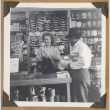 Woman helps a customer (ddr-densho-542-113)