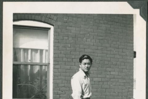 Kim Kawashima holding a camera (ddr-densho-328-191)