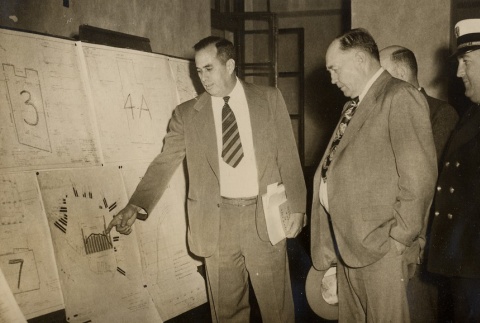 Man explaining city planning project to others (ddr-njpa-2-430)